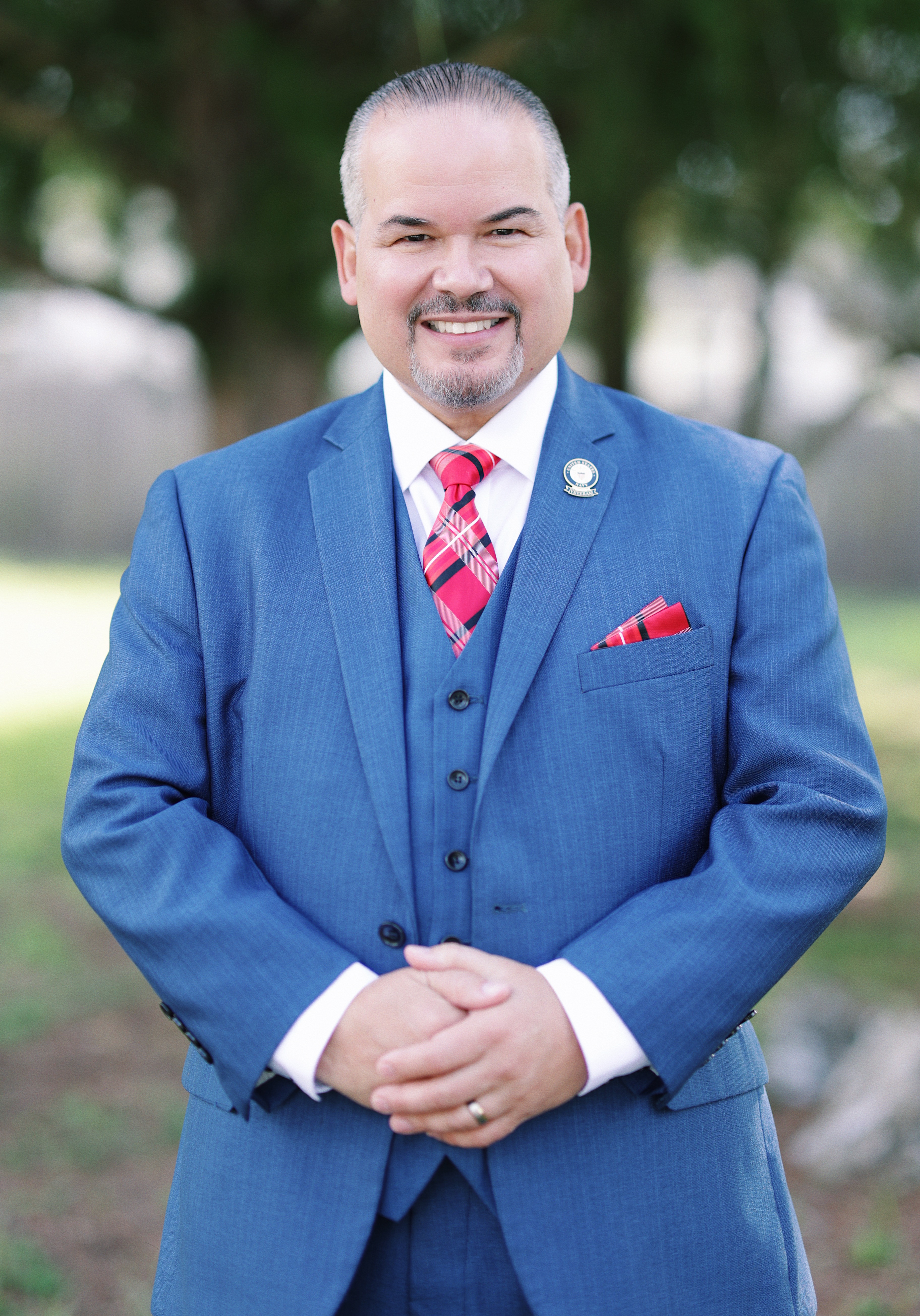 Jorge Malavet smiling and wearing a blue suit
